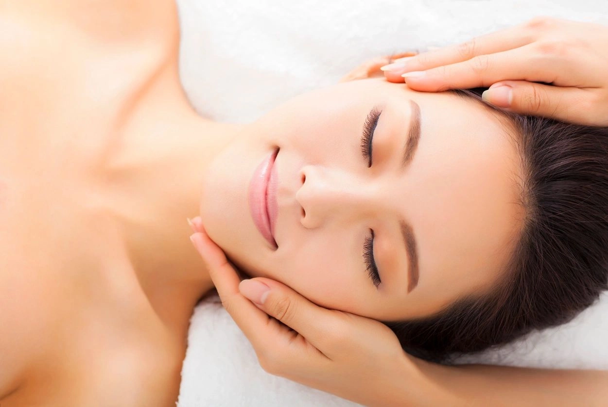 A woman laying down with her eyes closed.