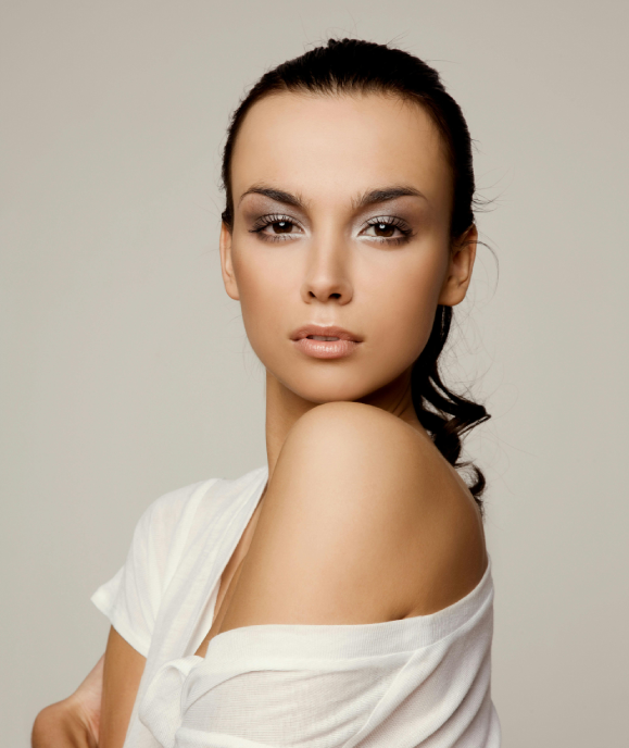 A woman with long hair and a white shirt.