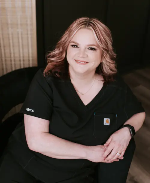 A woman in black shirt sitting on chair.